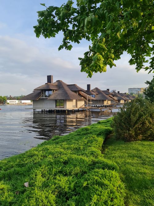 Free Explore luxurious floating bungalows along the river in Dnipro, surrounded by lush greenery and calm waters. Stock Photo