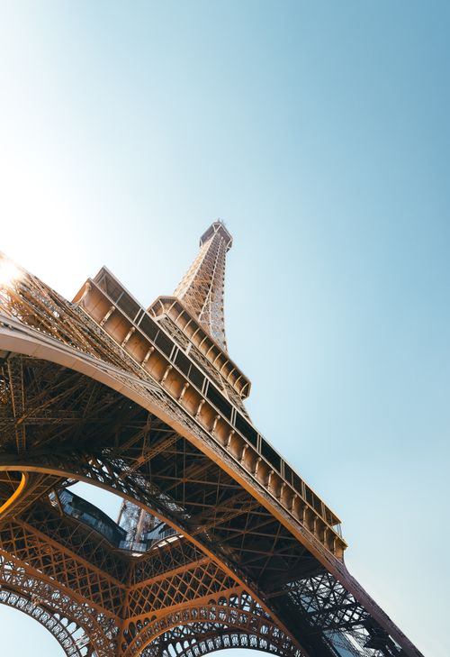 Free Stunning low angle shot of the Eiffel Tower in Paris with a clear blue sky, perfect for travel enthusiasts. Stock Photo