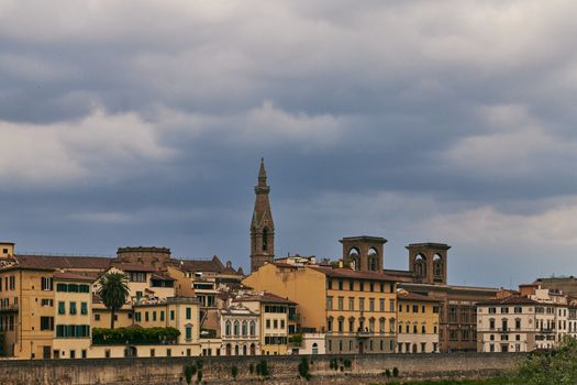 Explore Florence's iconic skyline with its historic buildings and towers under an overcast sky.