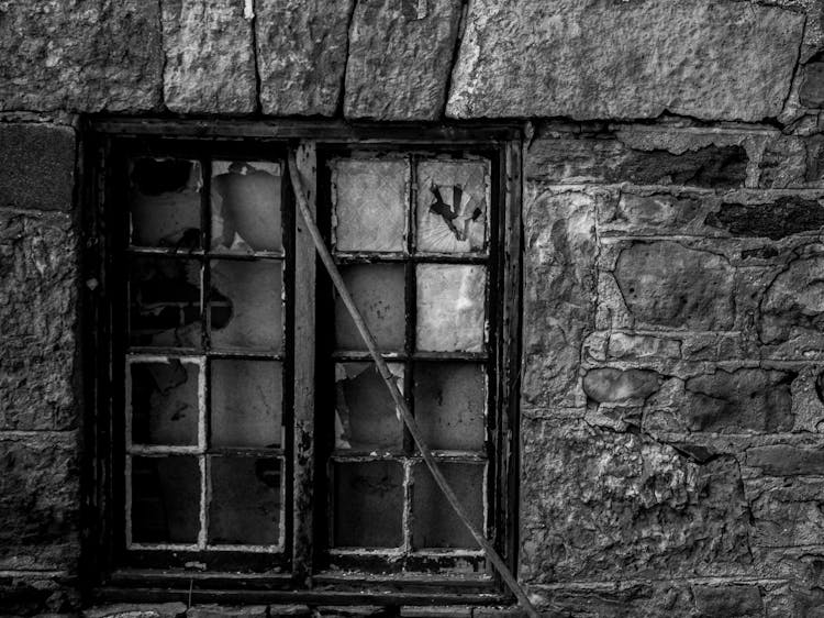 Broken Window On Old Stone Building