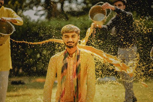 Vibrant Indian wedding ritual with splashing colors and joyful celebration.