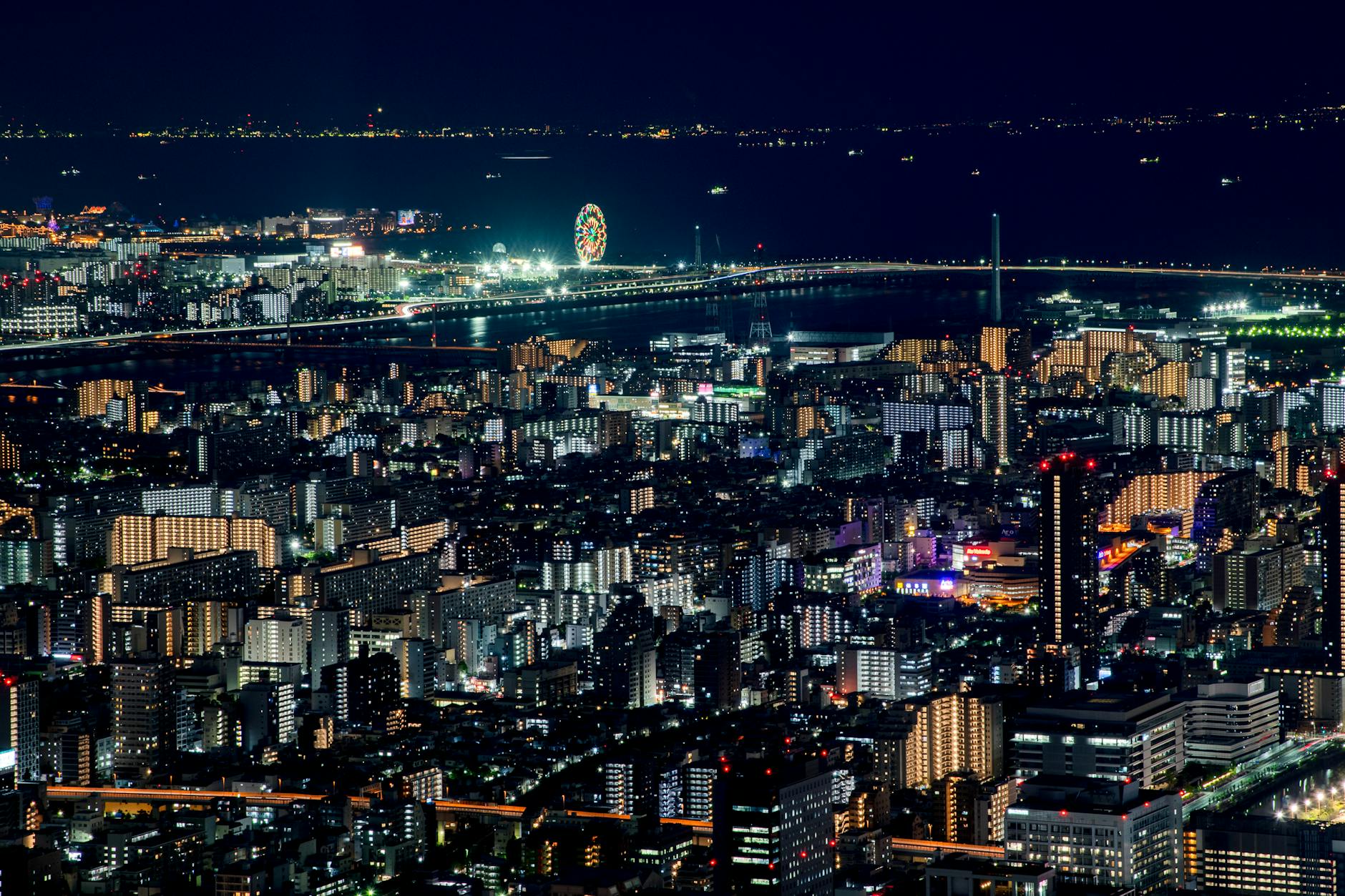 Breathtaking night view of Tokyo with illuminated skyscrapers and vibrant city lights extending to the horizon.