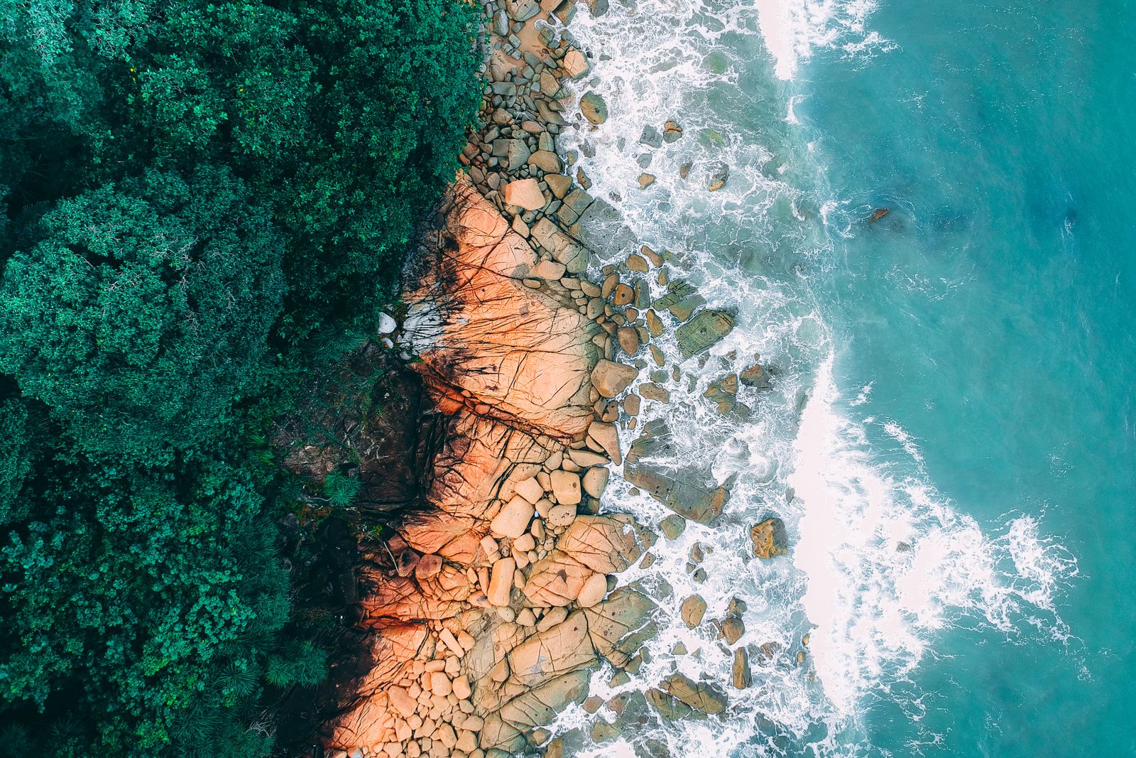 Aerial view of a lush tropical island surrounded by turquoise water