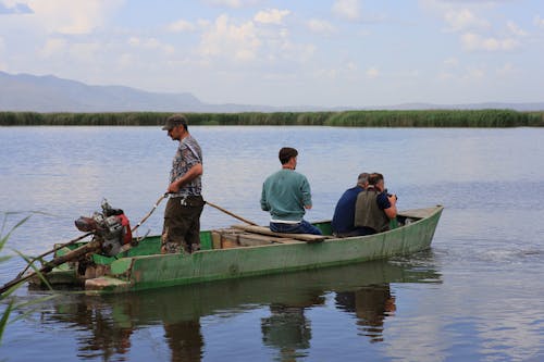 Four Men in a Motor Boat Going to a Photo Shoot on a Lake