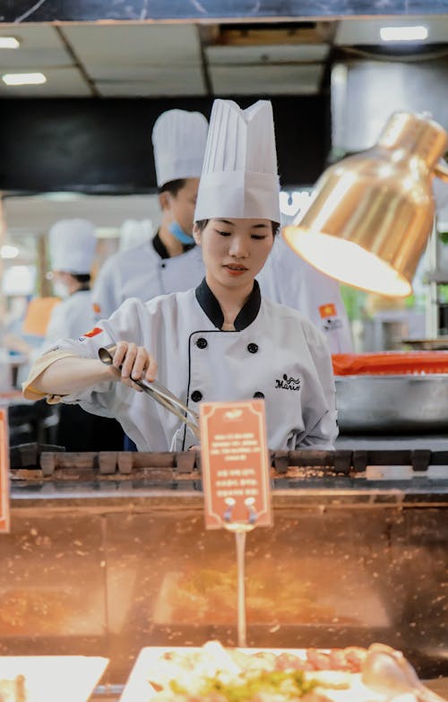 Woman Preparing Food in Restaurant Kitchen 