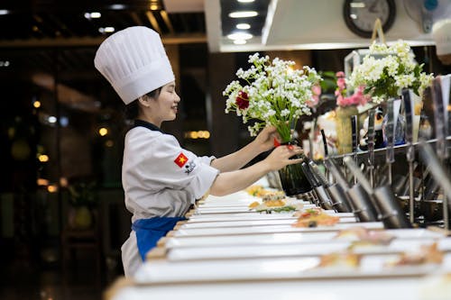 Woman in a Commercial Kitchen Making a Bouquet of Flowers 