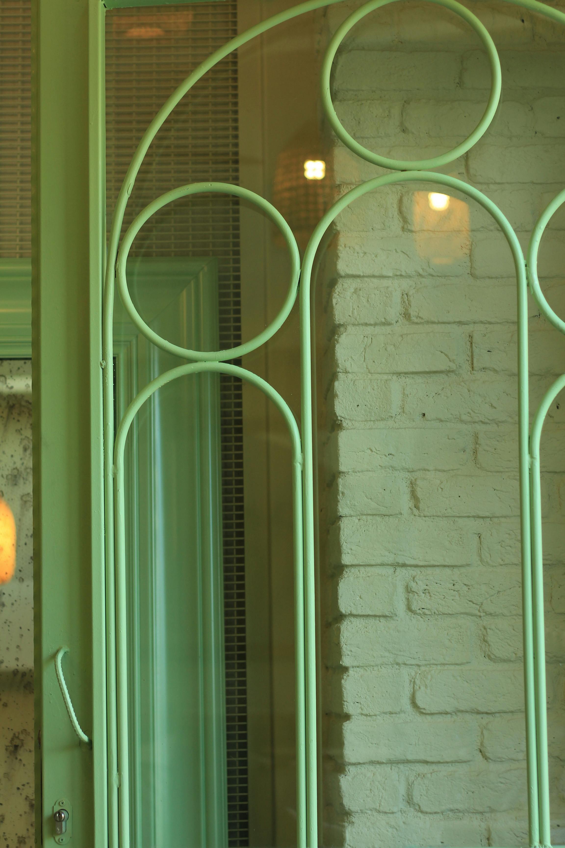 A green glass door with a green frame · Free Stock Photo