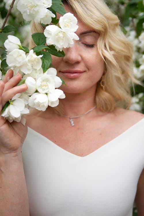 Blonde Woman behind Flowers