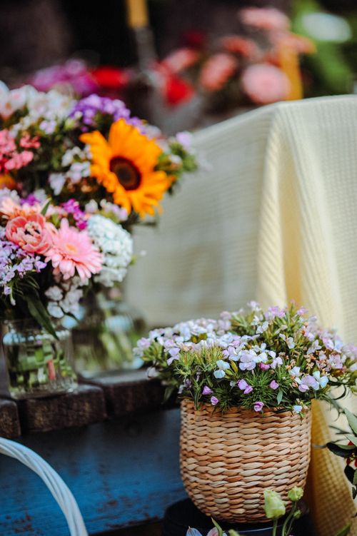 Free Vibrant floral arrangements in baskets showcasing a variety of flowers outdoors. Stock Photo