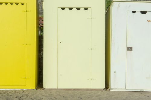 Free Vibrant changing booths at the sandy beach in Batz-sur-Mer, France, under the summer sun. Stock Photo