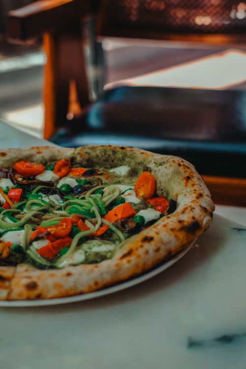 Free A mouth-watering vegetable pizza with fresh ingredients on a marble table in Ankara, Türkiye. Stock Photo