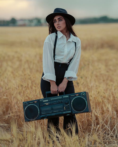 Model Posing with Boom Box in Field