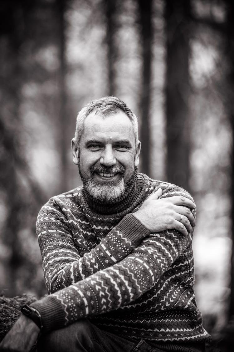 Black And White Portrait Of A Smiling Bearded Man Wearing A Sweater