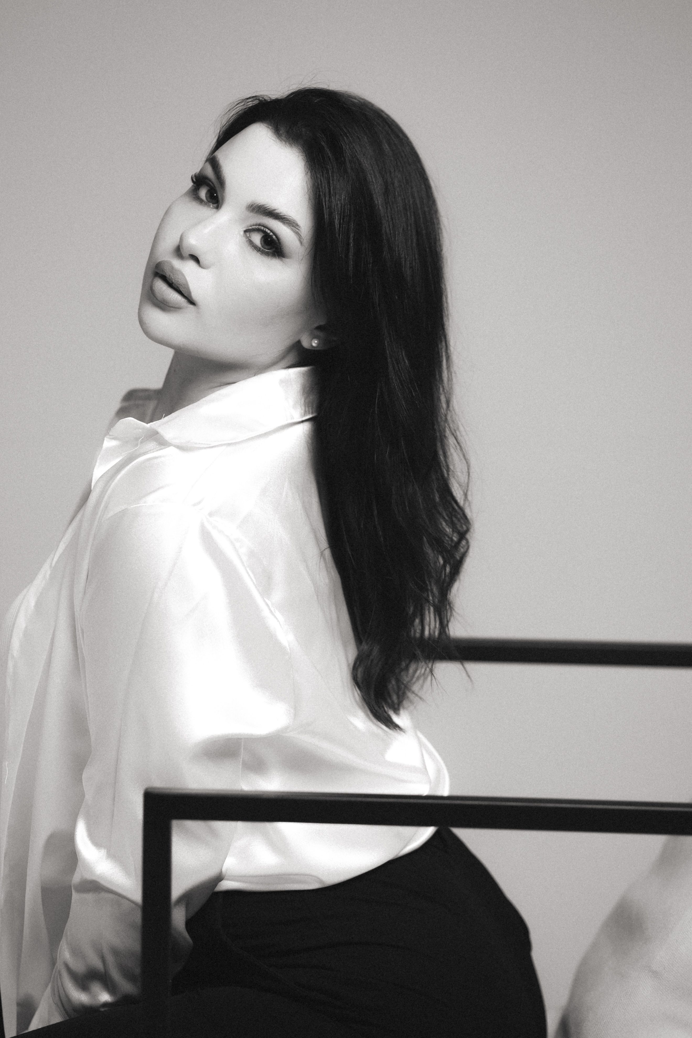 woman in black satin trousers and ivory silk shirt