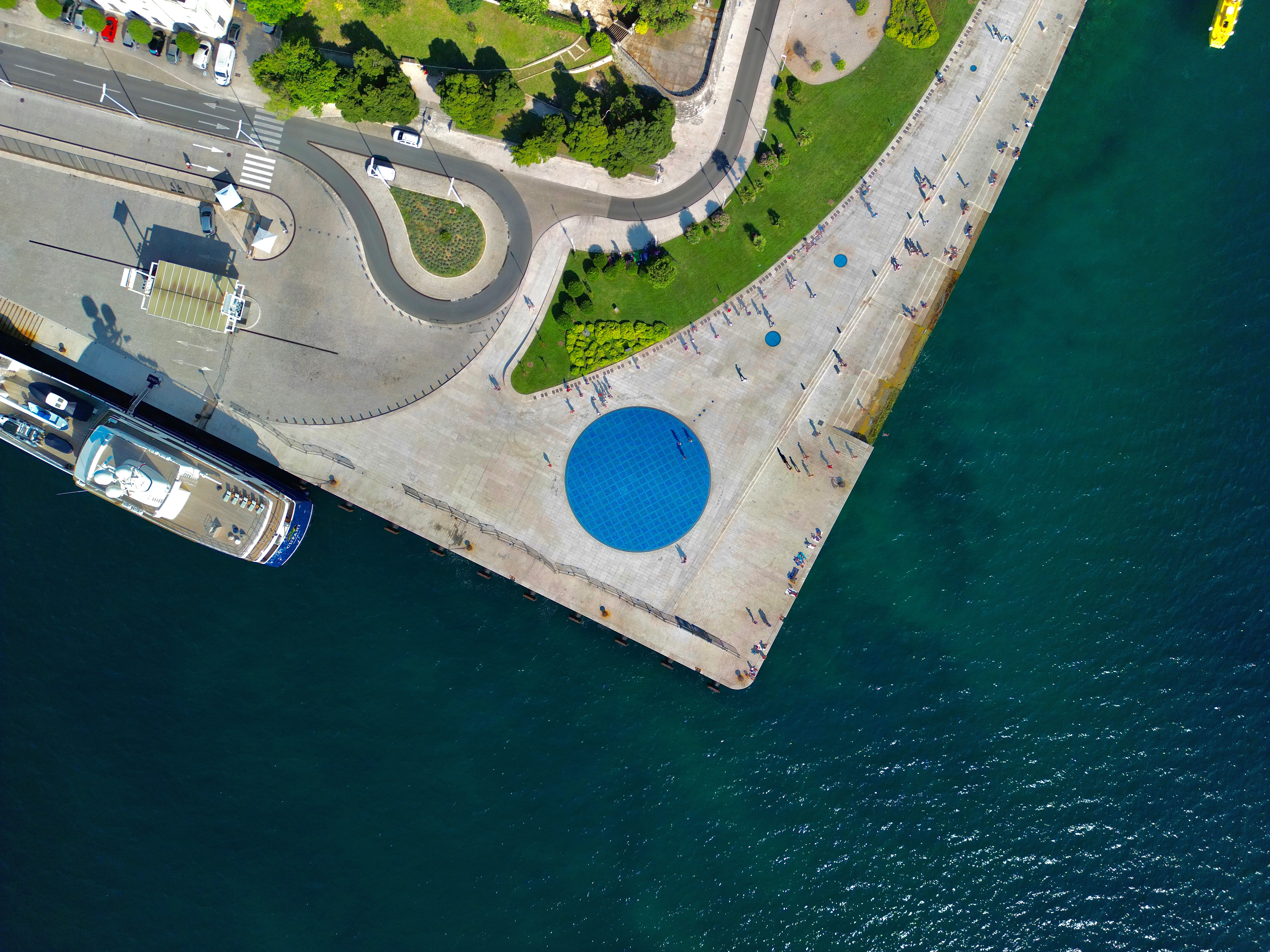 Aerial shot of Zadar's promenade with the Sea Organ and clear Adriatic waters, Croatia