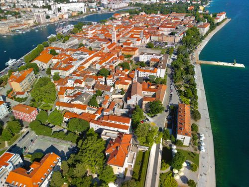 Free Discover the charming coastal town of Zadar, Croatia, with its vibrant orange-roofed buildings and stunning waterfront views. Stock Photo