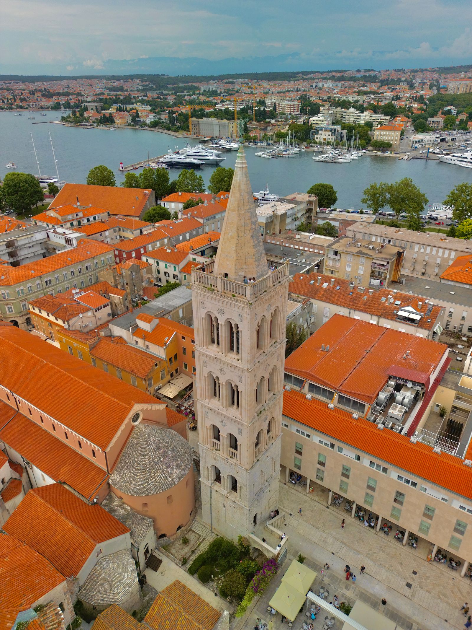 Aerial view of Zadar's old town, bell tower, orange roofs, and marina