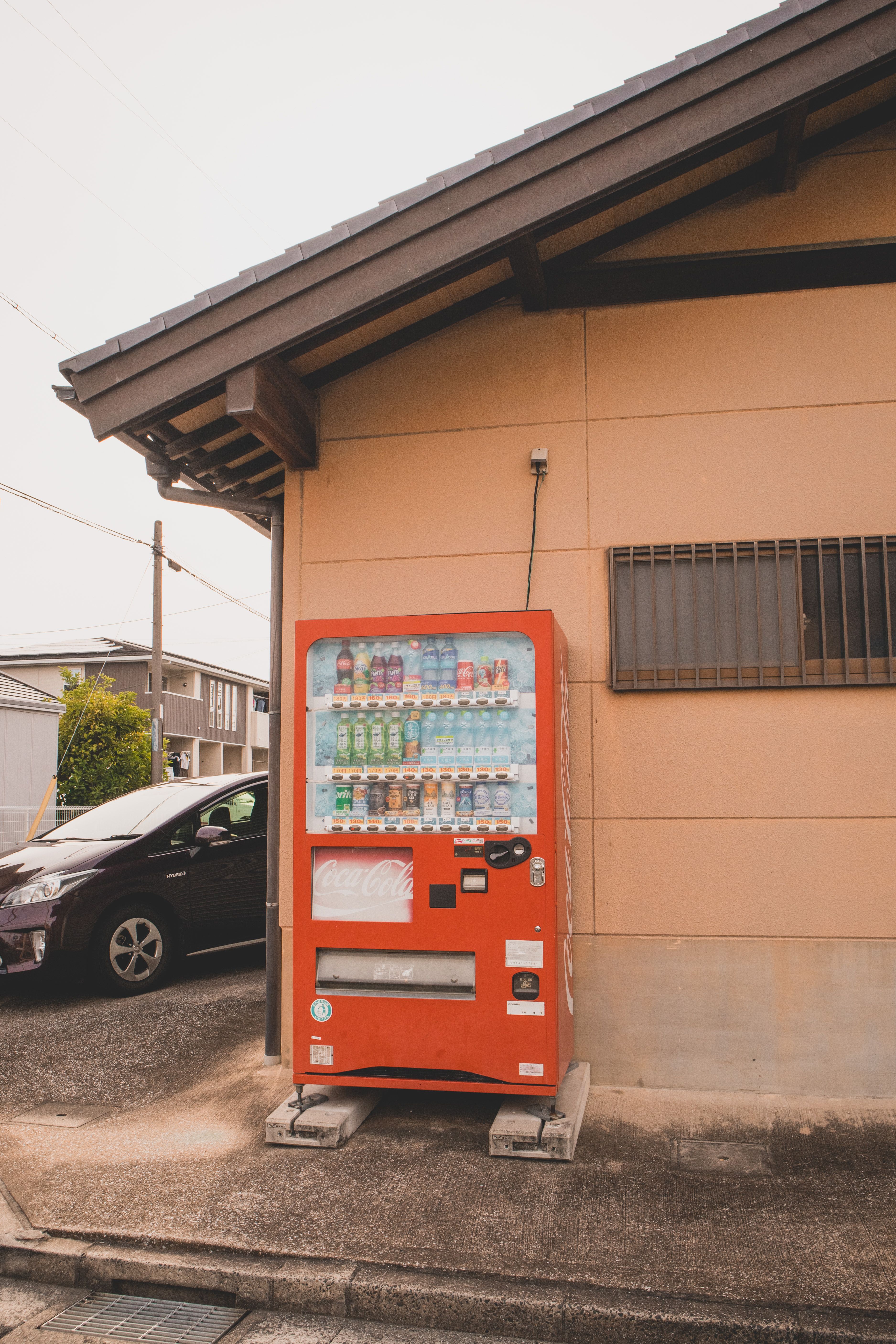 Vending Machine with Drinks Standing by a Building · Free Stock Photo