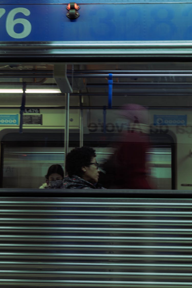 Candid Picture Of People In A Subway Photographed From The Outside 