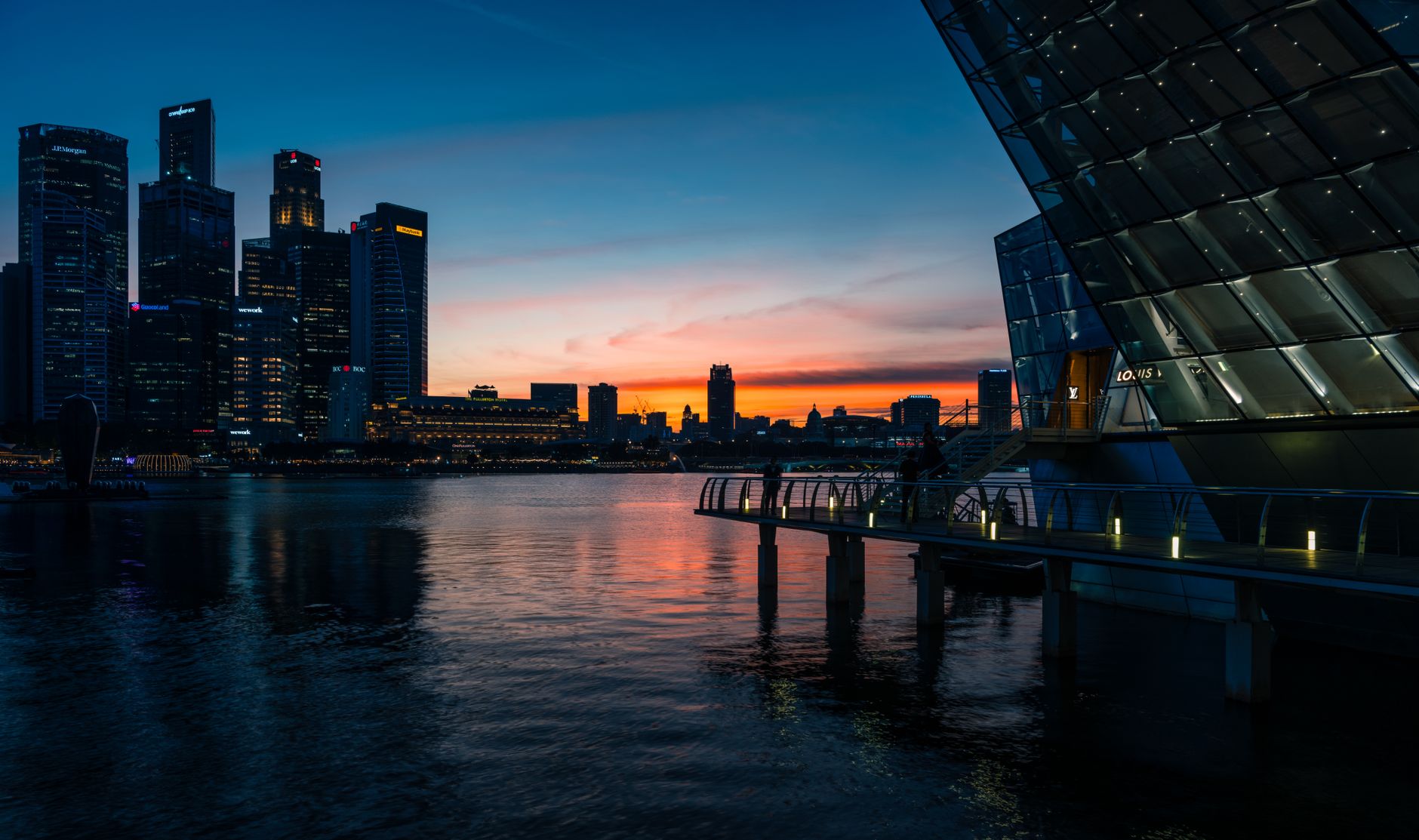 A sophisticated, minimalist executive office space overlooking a modern global financial district skyline at dusk.