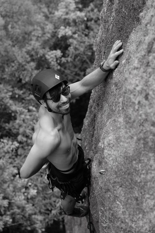 Smiling Topless Man Rock Climbing