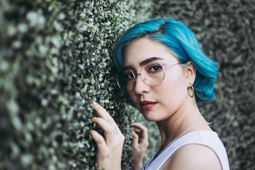 Free Close-Up Photo of Woman Leaning On Bush Stock Photo