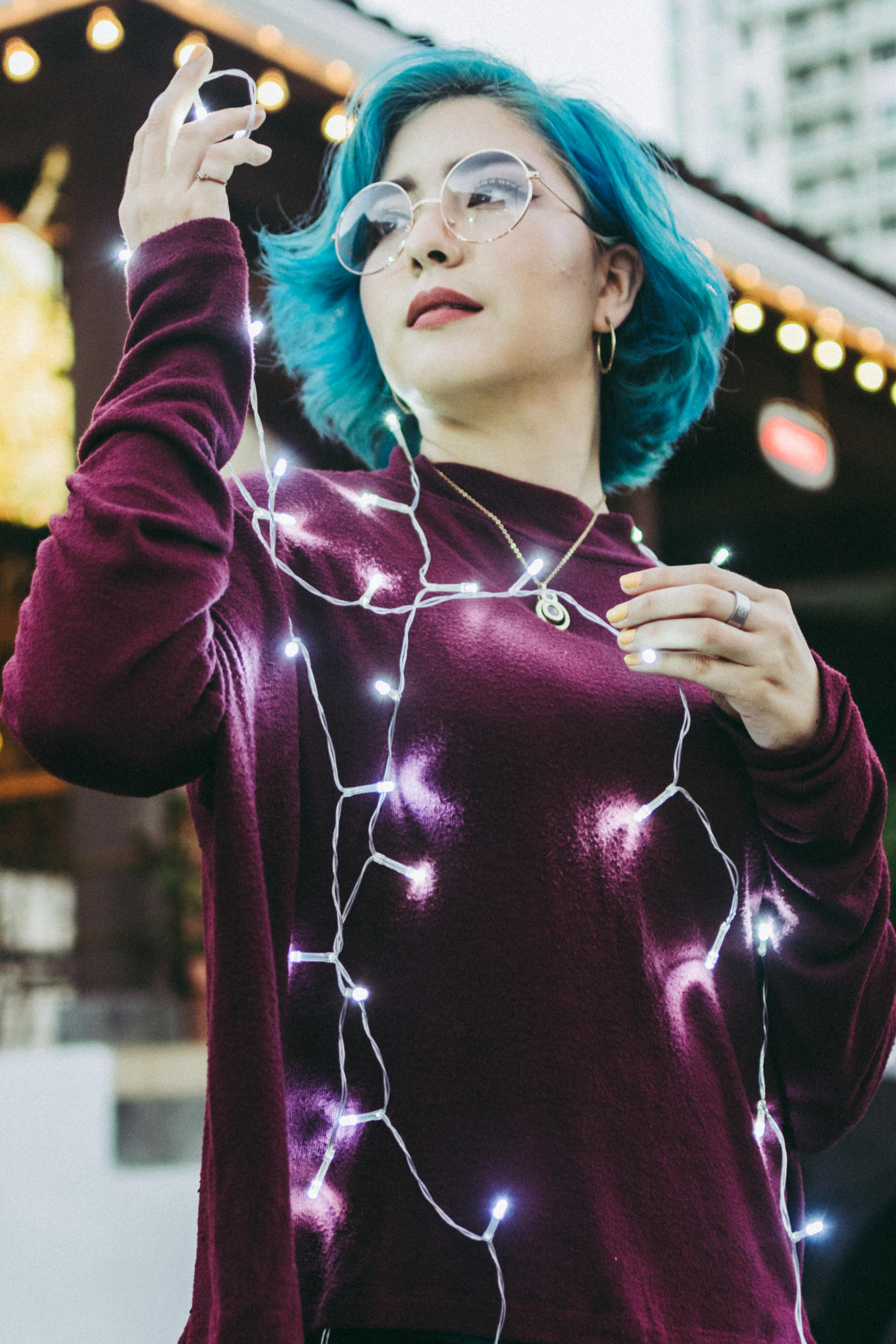 Photo of Woman Holding String Lights