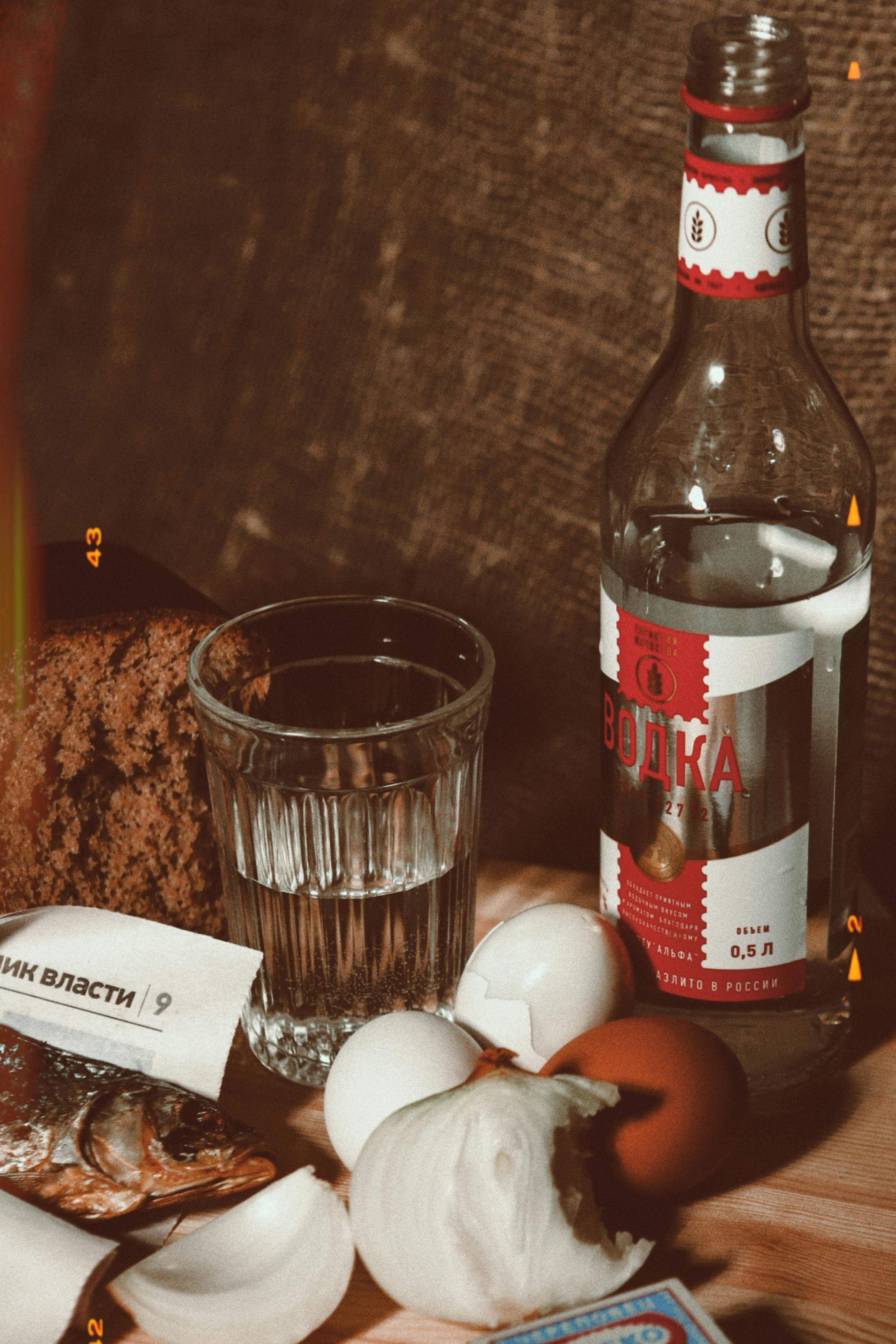 A bottle of vodka, eggs, and other ingredients · Free Stock Photo