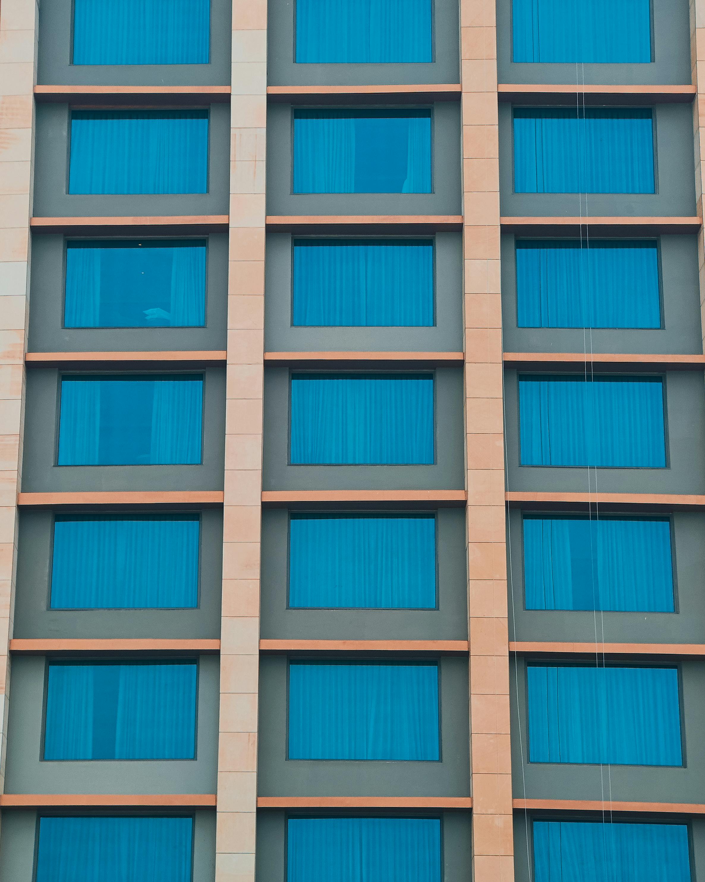 Close-up of a modern building façade with blue-tinted windows in Bhopal, India.