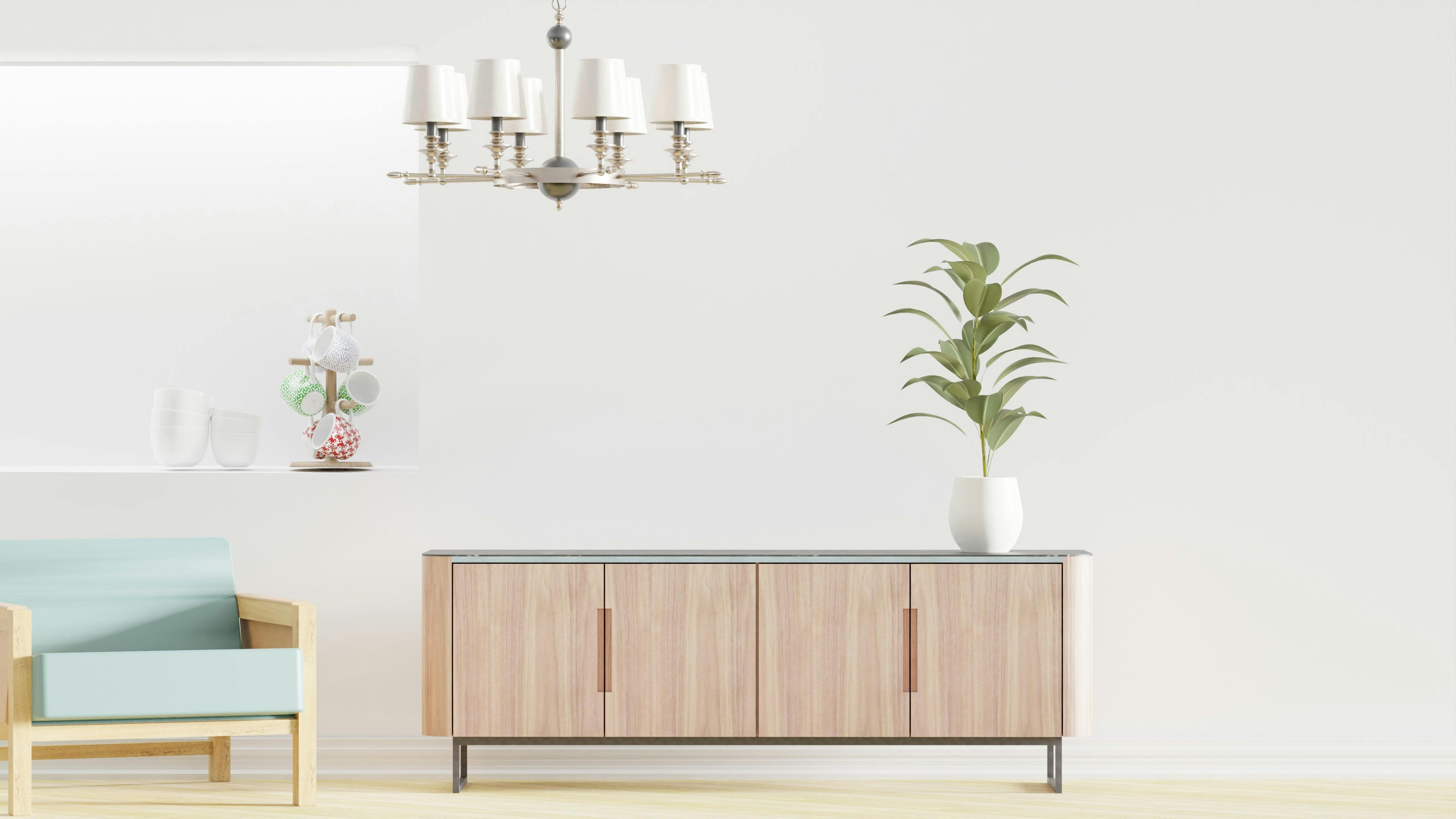 Elegant minimalist room with a wooden armchair, sideboard, and potted plant under soft lighting. 