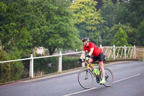 A man riding a bike on a bridge