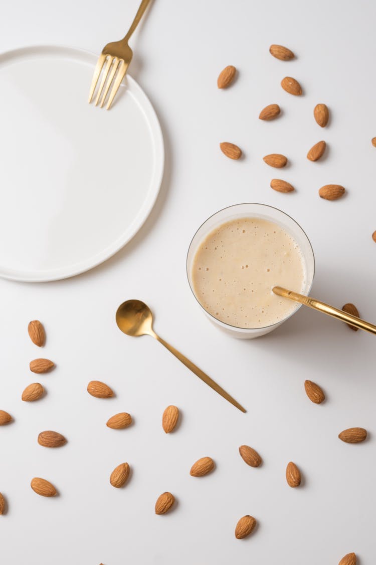 Almonds, Cutlery And Glass Of Milky Drink