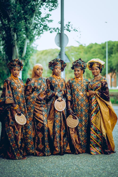 Young Women Wearing Traditional Gowns and Turbans