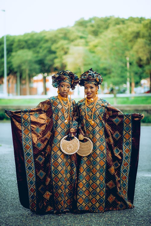 Young Women Wearing Traditional Gowns and Turbans