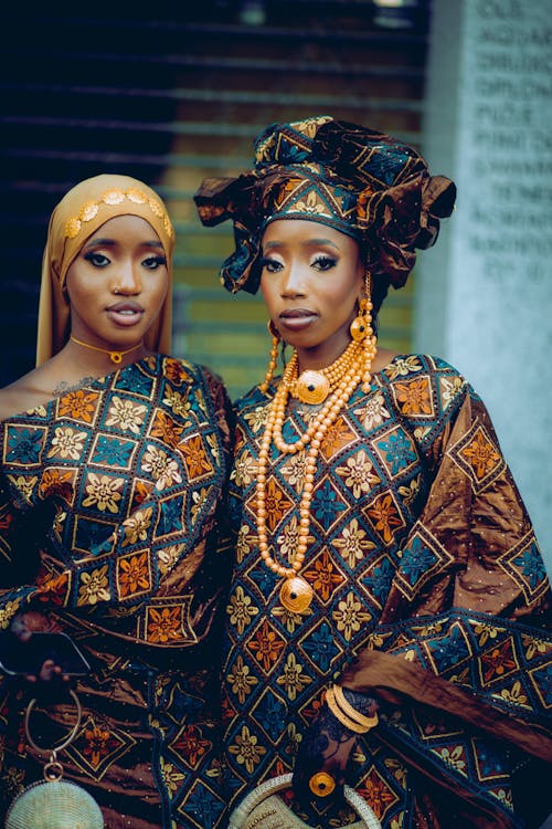 Young Women Wearing Traditional Gowns and Turbans