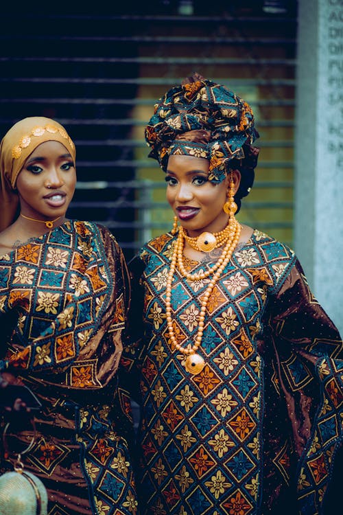 Young Women Wearing Traditional Gowns and Turbans