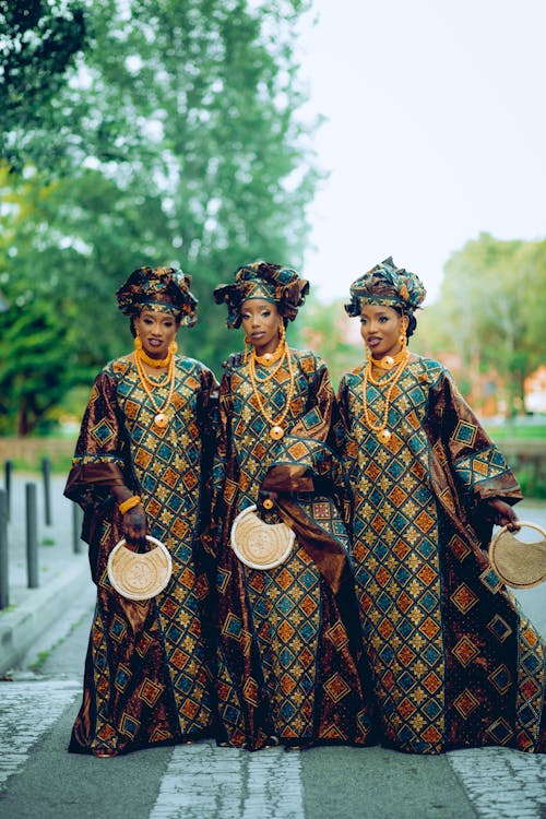 A Group of Women in Traditional Clothing Posing Outside 