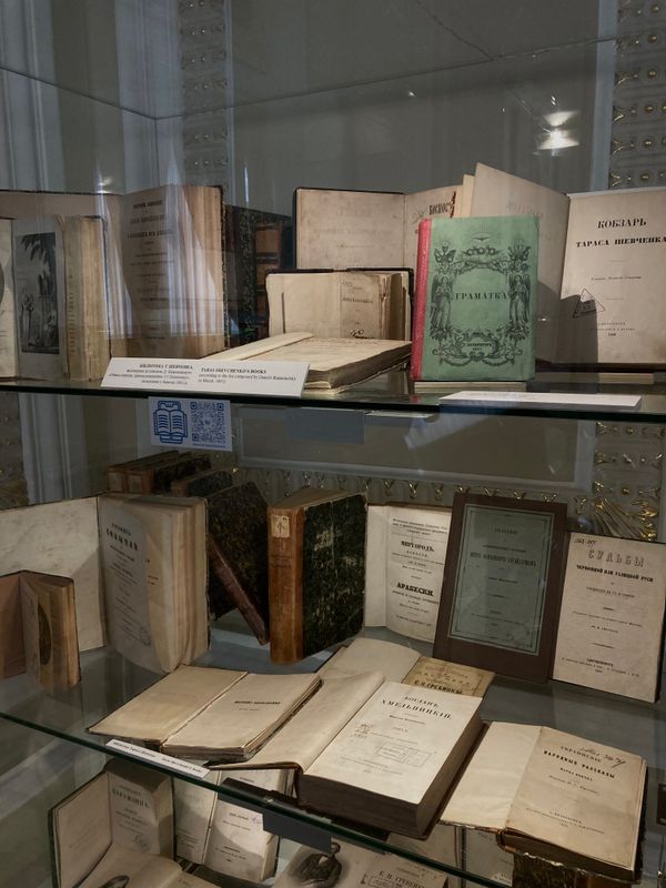 Antique books in a glass cabinet in a museum