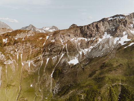 Majestic aerial view of the rocky mountains in Malbun, Liechtenstein, showcasing natural beauty and rugged terrain.