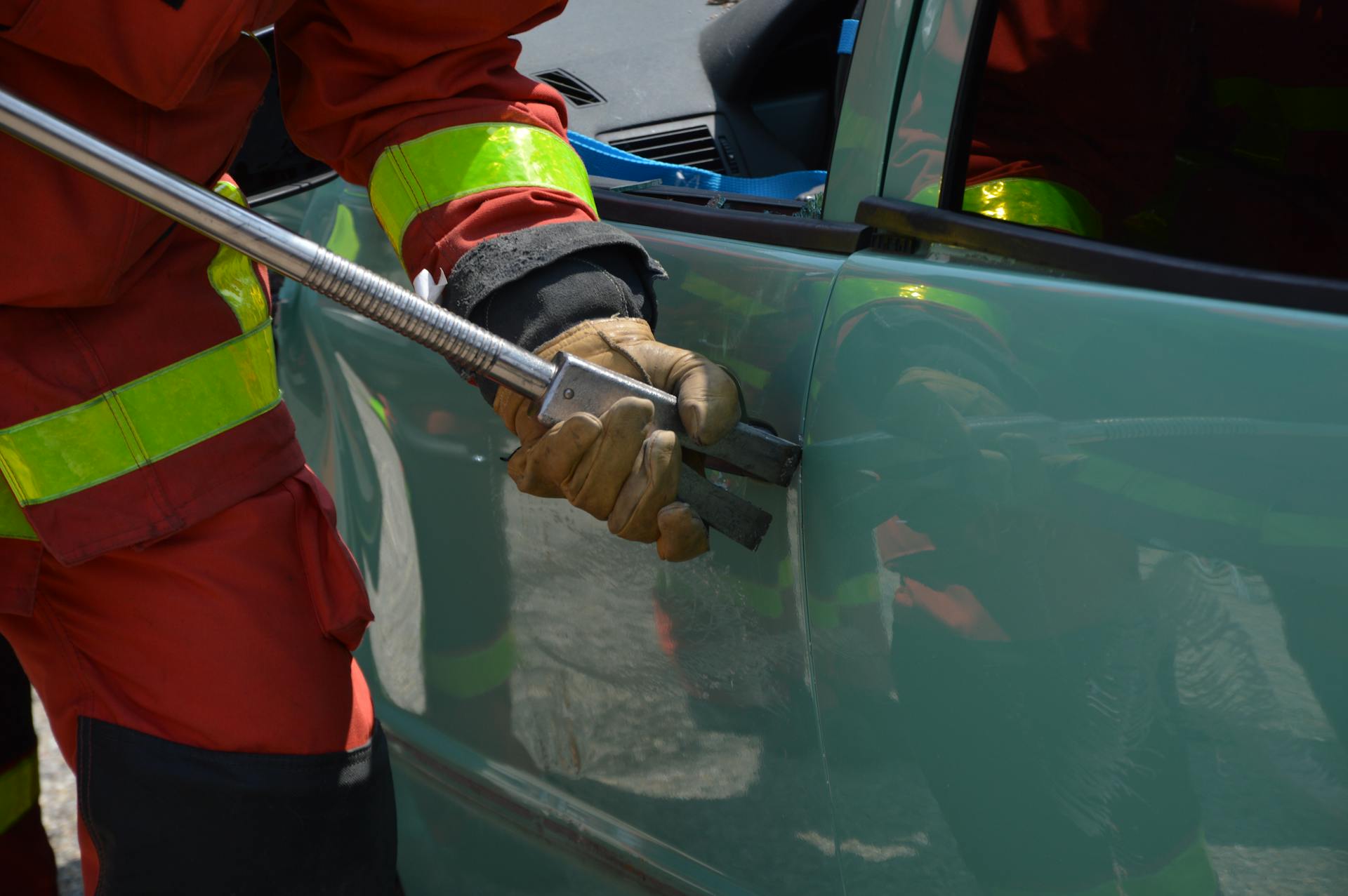 Fireman Opening Jammed Door of a Crushed Car