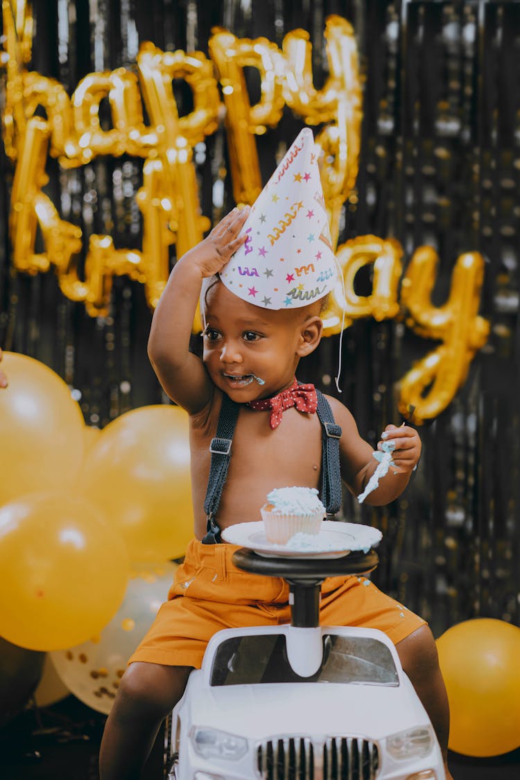 Birthday Boy Sitting On Toy Car