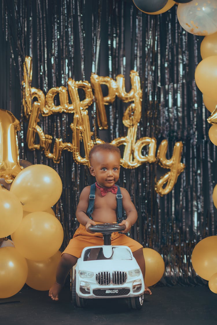 Smiling Birthday Boy On Toy Car