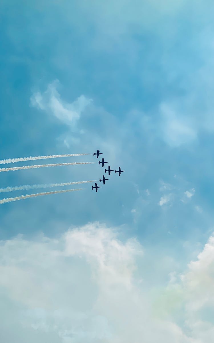 Planes Flying In A Formation At Airshow Leaving White Smoke Trails