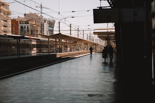 Silhouette of Passengers at a Railway Station Platform