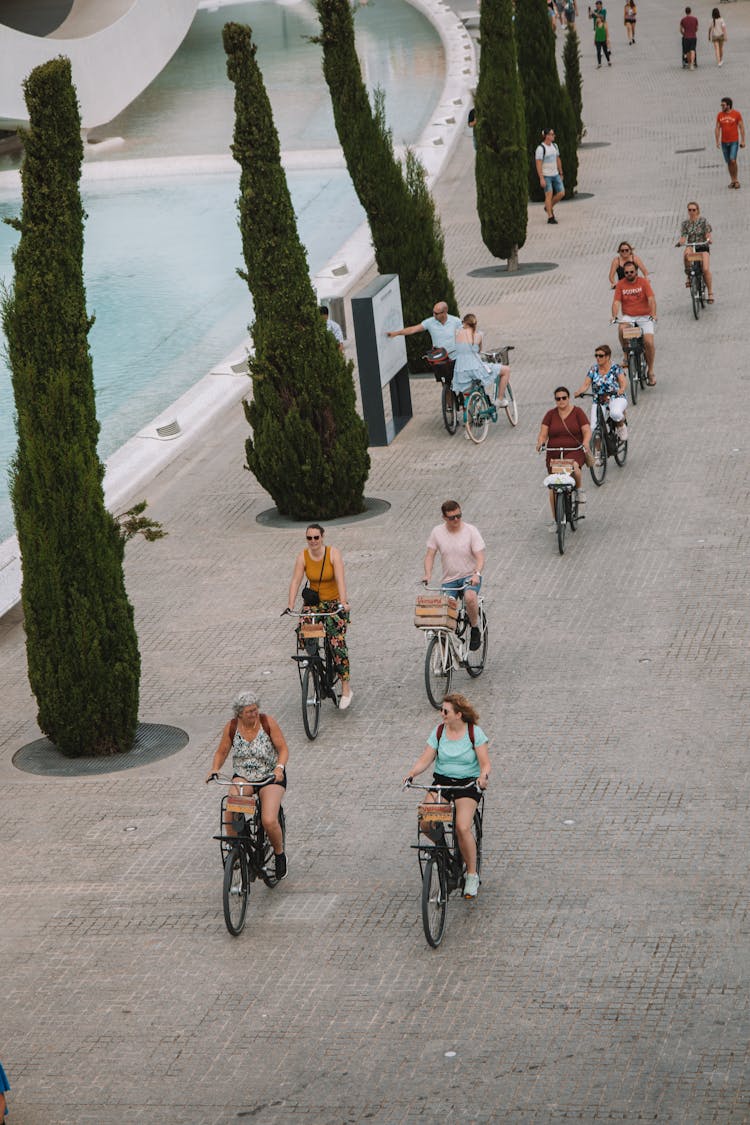 Group Of People Riding Bicycles Near Palau De Les Arts, Valencia, Spain