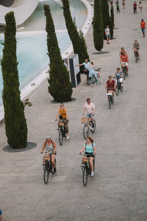 Free Group of cyclists in Valencia, Spain, near Palau de les Arts, enjoying a sunny ride. Stock Photo
