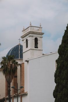 Elegant bell tower and blue-tiled dome in Valencia, Spain architecture