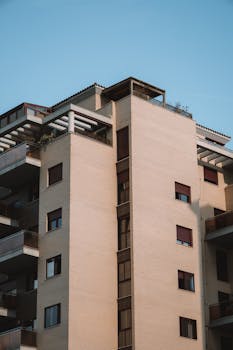 A contemporary high-rise apartment building in Valencia, Spain under a clear sky.