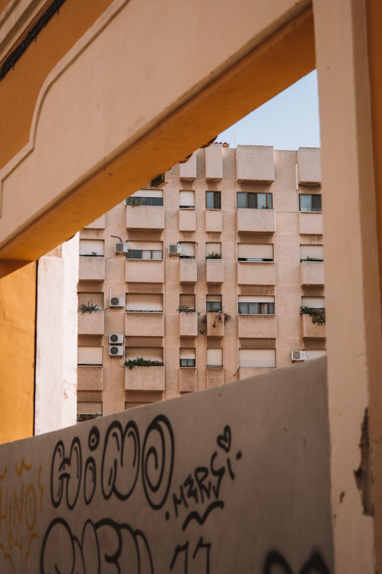 Graffiti On The Wall And A City Apartment Building 