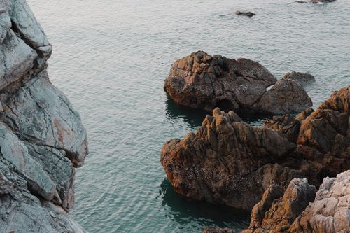 Free Explore stunning coastal rock formations with serene sea views from a high angle. Stock Photo